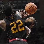
              Grambling State's Prince Moss (22) is fouls Connecticut's R.J. Cole in the first half of an NCAA college basketball game, Saturday, Dec. 4, 2021, in Storrs, Conn. (AP Photo/Jessica Hill)
            