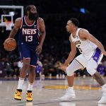 
              Los Angeles Lakers guard Talen Horton-Tucker (5) defends against Brooklyn Nets guard James Harden (13) during the first half of an NBA basketball game in Los Angeles, Saturday, Dec. 25, 2021. (AP Photo/Ashley Landis)
            