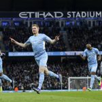 
              Manchester City's Kevin De Bruyne, center, celebrates after scoring the opening goal during the English Premier League soccer match between Manchester City and Leicester City at Etihad stadium in Manchester, England, Sunday, Dec. 26, 2021. (AP Photo/Scott Heppell)
            
