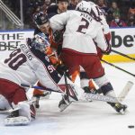
              Columbus Blue Jackets goalie Elvis Merzlikins (90) makes a save as Edmonton Oilers' Jesse Puljujarvi (13) and Blue Jackets' Andrew Peeke (2) battle in front during second-period NHL hockey game action in Edmonton, Alberta, Thursday, Dec. 16, 2021. (Jason Franson/The Canadian Press via AP)
            