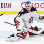 
              Columbus Blue Jackets goaltender Elvis Merzlikins watches the puck during the second period of the team's NHL hockey game against the Toronto Maple Leafs on Tuesday, Dec. 7, 2021, in Toronto. (Cole Burston/The Canadian Press via AP)
            