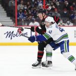 
              Ottawa Senators left wing Brady Tkachuk (7) battles for the puck with Vancouver Canucks defenseman Quinn Hughes (43) during the second period of an NHL hockey game, Wednesday, Dec.1, 2021 in Ottawa, Ontario. (Sean Kilpatrick/The Canadian Press via AP)
            