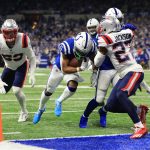
              Indianapolis Colts running back Nyheim Hines, center, scores between New England Patriots cornerback J.C. Jackson (27) and middle linebacker Kyle Van Noy (53) during the first half of an NFL football game Saturday, Dec. 18, 2021, in Indianapolis. (AP Photo/Aaron Doster)
            