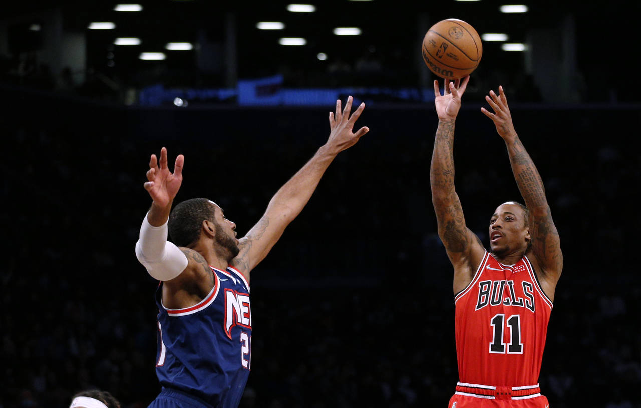 Chicago Bulls forward DeMar DeRozan (11) shoots over Brooklyn Nets center LaMarcus Aldridge (21) du...