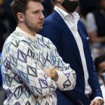 
              Dallas Mavericks guard Luka Doncic, left, and teammate center Kristaps Porzingis, right, watch their team play during the second half of an NBA basketball game against the Memphis Grizzlies, Saturday, Dec. 4, 2021, in Dallas. (AP Photo/Sam Hodde)
            