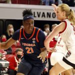 
              Virginia's Eleah Parker (21) tries to drive the ball around North Carolina State's Elissa Cunane (33) during the first half of an NCAA college basketball game, Sunday, Dec. 19, 2021, in Raleigh, N.C. (AP Photo/Karl B. DeBlaker)
            