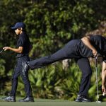 
              Tiger Woods, right, and his son Charlie finish putting on the second hole during the first round of the PNC Championship golf tournament Friday, Dec. 17, 2021, in Orlando, Fla. Woods is back playing after getting injured in a car accident. He is paired Charlie during the tournament. (AP Photo/Scott Audette)
            