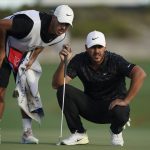 
              Brooks Koepka, of the United States, right, speaks with his caddie on the 18th green during the second round of the Hero World Challenge PGA Tour at the Albany Golf Club, in New Providence, Bahamas, Friday, Dec. 3, 2021.(AP Photo/Fernando Llano)
            