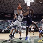 
              Vanderbilt forward Quentin Millora-Brown (42) tries to grab a rebound over BYU forward Fousseyni Traore in the first half of an NCAA college basketball game Thursday, Dec. 23, 2021, in Honolulu. (AP Photo/Marco Garcia)
            