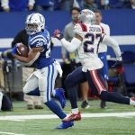 
              Indianapolis Colts running back Jonathan Taylor (28) runs past New England Patriots cornerback J.C. Jackson (27) on his way to a 67-yard touchdown during the second half of an NFL football game Saturday, Dec. 18, 2021, in Indianapolis. (AP Photo/AJ Mast)
            