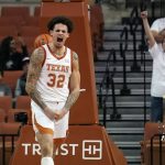 
              Texas forward Christian Bishop (32) reacts after scoring against Incarnate Word during the first half of an NCAA college basketball game, Tuesday, Dec. 28, 2021, in Austin, Texas. (AP Photo/Eric Gay)
            