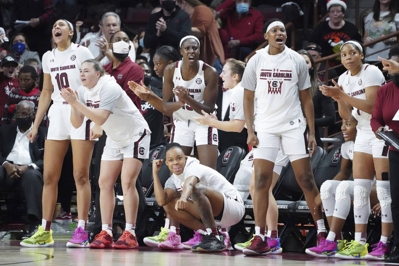 South Carolina players react to a score during the second half of the team's NCAA college basketbal...
