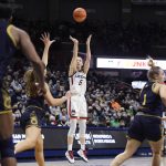 
              Connecticut's Paige Bueckers shoots over Notre Dame's Madelyn Westbeld (34) in the second half of an NCAA college basketball game, Sunday, Dec. 5, 2021, in Storrs, Conn. (AP Photo/Jessica Hill)
            