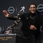 
              Alabama quarterback Bryce Young poses for a photograph after winning the Heisman Trophy, Saturday, Dec. 11, 2021, in New York. (AP Photo/John Minchillo)
            