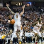 
              Alabama State guard DJ Jackson, left, passes the ball around Texas center Timmy Allen (0) during the first half of an NCAA college basketball game, Wednesday, Dec. 22, 2021, in Austin, Texas. (AP Photo/Michael Thomas)
            