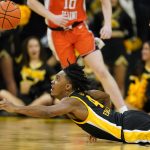 
              Iowa guard Ahron Ulis dives for a loose ball during the second half of an NCAA college basketball game against Illinois, Monday, Dec. 6, 2021, in Iowa City, Iowa. Illinois won 87-83. (AP Photo/Charlie Neibergall)
            