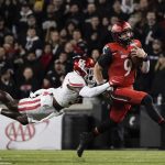
              Cincinnati quarterback Desmond Ridder (9) is tackled by Houston's Gervarrius Owens during the second half of the American Athletic Conference championship NCAA college football game Saturday, Dec. 4, 2021, in Cincinnati. (AP Photo/Jeff Dean)
            