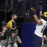 
              Michigan wide receiver Roman Wilson celebrates after catching a 75-yard touchdown pass during the first half of the Big Ten championship NCAA college football game against Iowa, Saturday, Dec. 4, 2021, in Indianapolis. (AP Photo/Darron Cummings)
            
