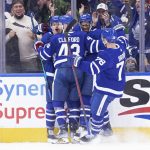 
              Toronto Maple Leafs' David Kampf, left, celebrates his goal against the Chicago Blackhawks with teammates Kyle Clifford, Wayne Simmonds and T.J. Brodie during third-period NHL hockey game action in Toronto, Saturday, Dec. 11, 2021. (Chris Young/The Canadian Press via AP)
            