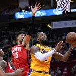 
              Los Angeles Lakers forward LeBron James, right, shoots as Houston Rockets center Christian Wood (35) defends during the first half of an NBA basketball game Tuesday, Dec. 28, 2021, in Houston. (AP Photo/Eric Christian Smith)
            