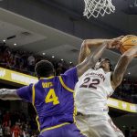
              Auburn guard Allen Flanigan (22) is fouled by LSU forward Darius Days (4) as he goes up for a shot during the second half of an NCAA college basketball game Wednesday, Dec. 29, 2021, in Auburn, Ala. (AP Photo/Butch Dill)
            