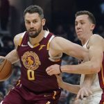 
              Cleveland Cavaliers' Kevin Love (0) drives against Miami Heat's Duncan Robinson (55) in the first half of an NBA basketball game, Monday, Dec. 13, 2021, in Cleveland. (AP Photo/Tony Dejak)
            