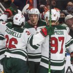 
              Minnesota Wild players celebrate a goal against the Edmonton Oilers during the third period of an NHL hockey game Tuesday, Dec. 7, 2021, in Edmonton, Alberta. (Jason Franson/The Canadian Press via AP)
            