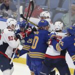 
              Washington Capitals and Buffalo Sabres players end up in a scrum during the third period of an NHL hockey game Saturday, Dec. 11, 2021, in Buffalo, N.Y. (AP Photo/Joshua Bessex)
            