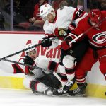 
              Ottawa Senators' Zach Sanford (13) joins teammate Dylan Gambrell (27) in vying for the puck against Carolina Hurricanes' Maxime Lajoie (42) during the first period of an NHL hockey game in Raleigh, N.C., Thursday, Dec. 2, 2021. (AP Photo/Karl B DeBlaker)
            