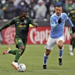 
              Portland Timbers midfielder Yimmi Chara (23) dribbles ahead of New York City FC midfielder Alfredo Morales (7) during the first half of the MLS Cup soccer match Saturday, Dec. 11, 2021, in Portland, Ore. (AP Photo/Amanda Loman)
            