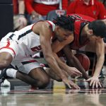 
              Texas Tech's Chibuzo Agbo (23) and Eastern Washington's Rylan Bergersen (11) dive for the loose ball during the second half of an NCAA college basketball game on Wednesday, Dec. 22, 2021, in Lubbock, Texas. (AP Photo/Brad Tollefson)
            