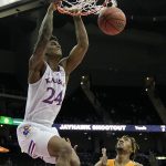 
              Kansas' K.J. Adams (24) gets past UTEP's Jamari Sibley to dunk the ball during the second half of an NCAA college basketball game Tuesday, Dec. 7, 2021, in Kansas City, Mo. (AP Photo/Charlie Riedel)
            
