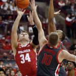 
              Wisconsin guard Brad Davison, left, goes up for a shot in front of Ohio State forward Justin Ahrens, center, and forward Zed Key during the first half of an NCAA college basketball game in Columbus, Ohio, Saturday, Dec. 11, 2021. (AP Photo/Paul Vernon)
            