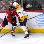 
              Chicago Blackhawks defenseman Jake McCabe, left, and Nashville Predators defenseman Alexandre Carrier battle for the puck during the second period of an NHL hockey game in Chicago, Friday, Dec. 17, 2021. (AP Photo/Nam Y. Huh)
            
