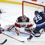 
              New Jersey Devils goaltender Jonathan Bernier (45) makes a save on Winnipeg Jets' Paul Stastny (25) during the second period of an NHL hockey game Friday, Dec. 3, 2021, in Winnipeg, Manitoba. (John Woods/The Canadian Press via AP)
            