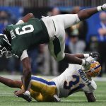
              Michigan State tight end Maliq Carr (6) falls to the turf after a catch against Pittsburgh defensive back Erick Hallett (31) during the second half of the Peach Bowl NCAA college football game, Thursday, Dec. 30, 2021, in Atlanta. (AP Photo/John Bazemore)
            