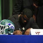 
              Green Run High School defensive tackle Lemar Law signs a national letter of intent for Virginia Tech during a national signing day event at Green Run High School in Virginia Beach, Va. on Wednesday, Dec. 15, 2021. (Trent Sprague /The Virginian-Pilot via AP)
            