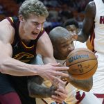 
              Cleveland Cavaliers forward Lauri Markkanen, left, and Miami Heat forward P.J. Tucker scramble for a loose ball during the first half of an NBA basketball game, Wednesday, Dec. 1, 2021, in Miami. (AP Photo/Wilfredo Lee)
            