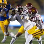 
              California wide receiver Nikko Remigio (4) gets away from Southern California defenders on his way to a first down during the first quarter of an NCAA college football game Saturday, Dec. 4, 2021, in Berkeley, Calif. (AP Photo/D. Ross Cameron)
            