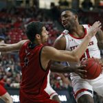 
              Texas Tech's KJ Allen (21) charges Eastern Washington's Rylan Bergersen (11) during the second half of an NCAA college basketball game on Wednesday, Dec. 22, 2021, in Lubbock, Texas. (AP Photo/Brad Tollefson)
            