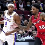 
              Los Angeles Lakers guard Rajon Rondo, left, drives as he looks to pass the ball against Chicago Bulls forward Alfonzo McKinnie during the first half of an NBA basketball game in Chicago, Sunday, Dec. 19, 2021. (AP Photo/Nam Y. Huh)
            