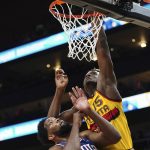 
              Atlanta Hawks center Clint Capela (15) goes up for a basket as Philadelphia 76ers center Joel Embiid (21) defends during the first half of an NBA basketball game Friday, Dec. 3, 2021, in Atlanta. (AP Photo/John Bazemore)
            