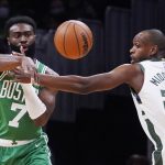 
              Boston Celtics guard Jaylen Brown (7) passes the ball while pressured by Milwaukee Bucks forward Khris Middleton (22) during the first half of an NBA basketball game, Monday, Dec. 13, 2021, in Boston. (AP Photo/Charles Krupa)
            