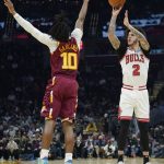 
              Chicago Bulls' Lonzo Ball (2) shoots over Cleveland Cavaliers' Darius Garland (10) in the first half of an NBA basketball game, Wednesday, Dec. 8, 2021, in Cleveland. (AP Photo/Tony Dejak)
            
