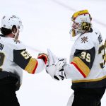
              Vegas Golden Knights goalie Laurent Brossoit (39) celebrates with defenseman Dylan Coghlan (52) as time expires in the team's NHL hockey game against the Arizona Coyotes on Friday, Dec. 3, 2021, in Glendale, Ariz. The Golden Knights won 7-1. (AP Photo/Ross D. Franklin)
            