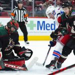 
              Arizona Coyotes goalie Scott Wedgewood (31) makes a save on a shot by New York Rangers right wing Julien Gauthier (15) as Coyotes defenseman Dysin Mayo (61) applies pressure during the second period of an NHL hockey game Wednesday, Dec. 15, 2021, in Glendale, Ariz. (AP Photo/Ross D. Franklin)
            