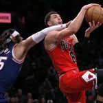 
              Chicago Bulls guard Zach LaVine (8) is fouled on his way to the basket by Brooklyn Nets' DeAndre Bembry (95) during the first half of an NBA basketball game in New York, Saturday, Dec. 4, 2021. (AP Photo/Noah K. Murray)
            