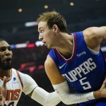 
              Los Angeles Clippers guard Luke Kennard (5) is defended by Phoenix Suns forward Jae Crowder (99) during the first half of an NBA basketball game in Los Angeles, Monday, Dec. 13, 2021. (AP Photo/Ashley Landis)
            
