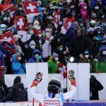 
              Switzerland's Wendy Holdener salutes supporters in the finish area of an alpine ski, women's World Cup super-G in St. Moritz, Switzerland, Saturday, Dec. 11, 2021. (AP Photo/Pier Marco Tacca)
            