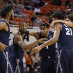 
              Xavier guard Nate Johnson, second from left, and guard Paul Scruggs, center, huddle with teammates in the second half of an NCAA college basketball game against Oklahoma State, Sunday, Dec. 5, 2021, in Stillwater, Okla. (AP Photo/Sue Ogrocki)
            
